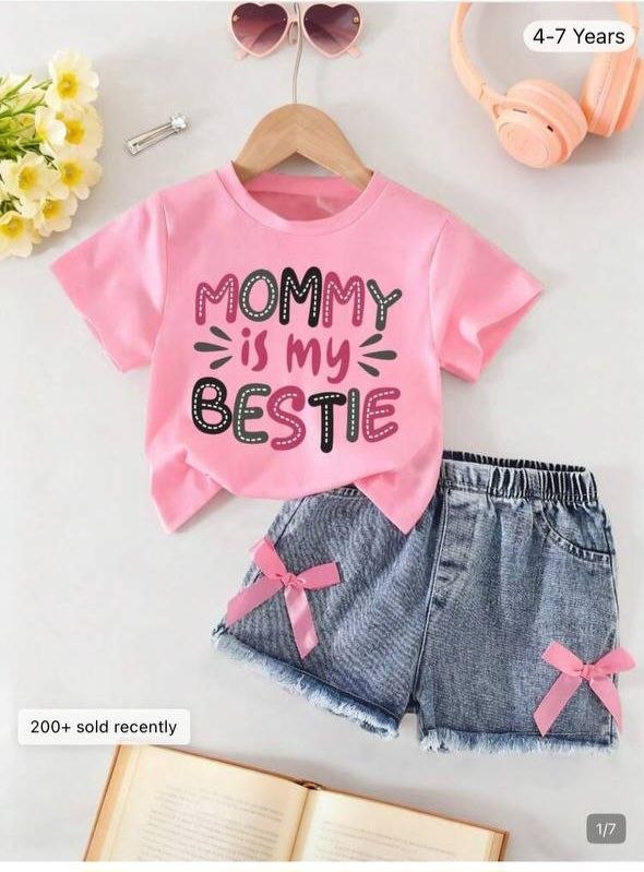 Cute toddler outfit features a pink top and jeans skirt