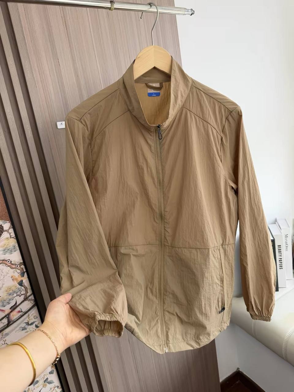 Lightweight, tan mock-neck windbreaker jacket