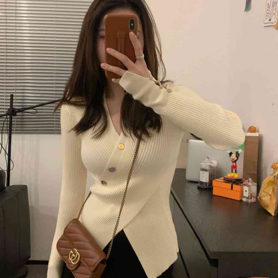 Cream colored asymmetrical ribbed knit cardigan