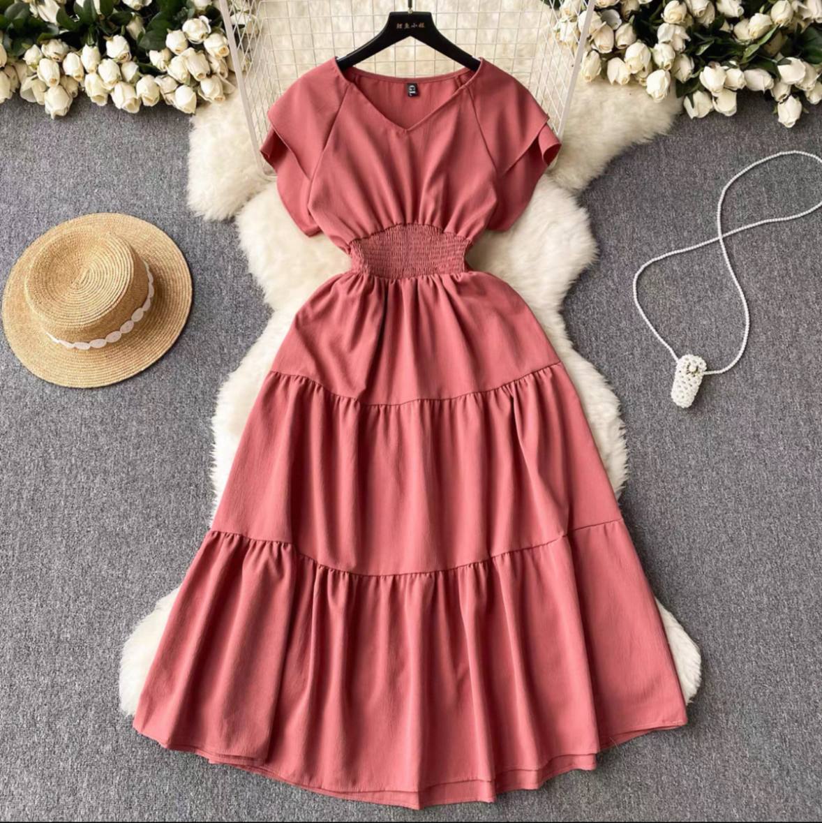 Pink tiered midi dress with a smocked waist and a V-neck