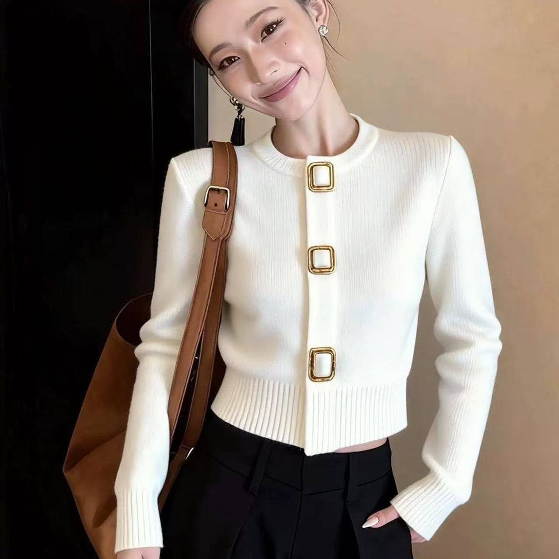 white cropped knit cardigan featuring large, decorative square buckle style statement buttons