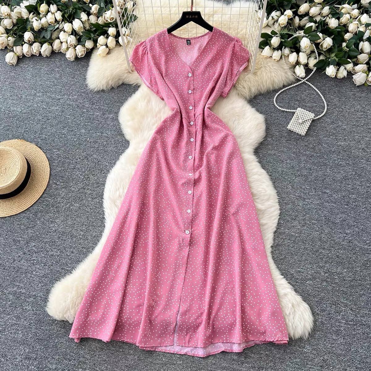 Pink button-down short-sleeve midi dress featuring a white polka dot pattern