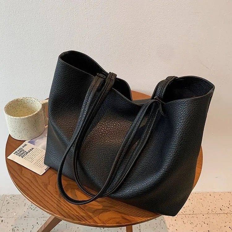 Minimalist black pebbled leather tote bag