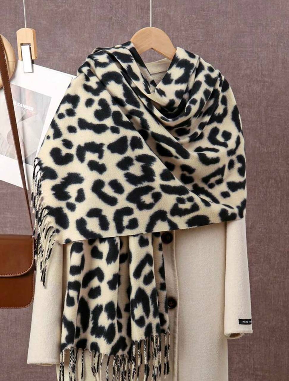 Cozy beige and black leopard-print cashmere-feel winter scarf features classic fringed tassel hems