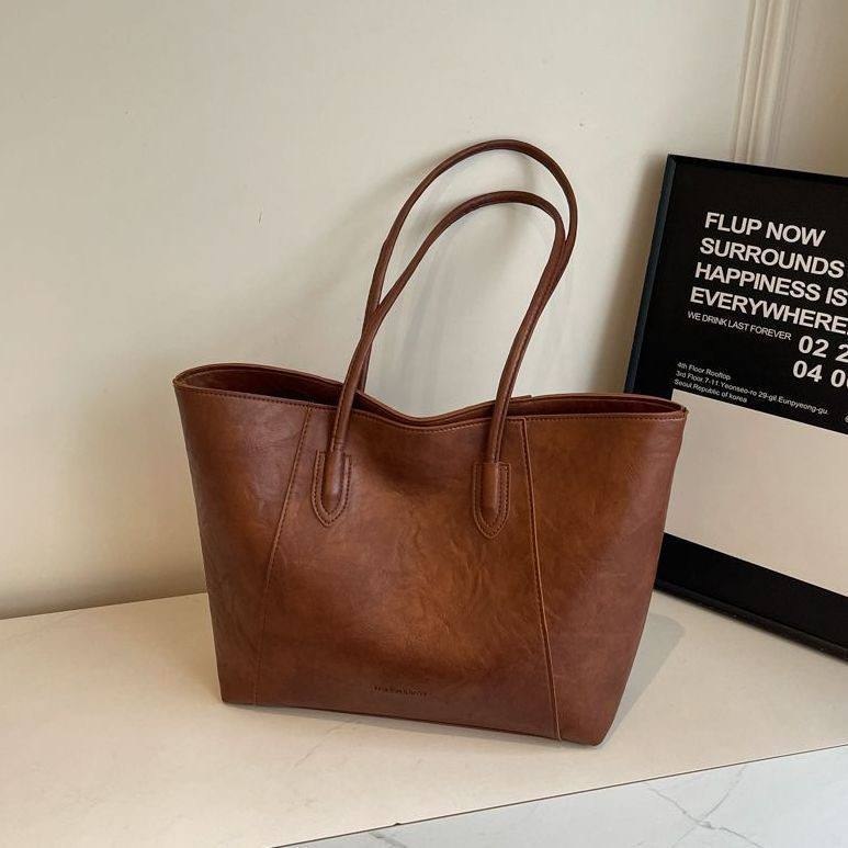 Oversized, vintage-style faux leather commuter tote bag