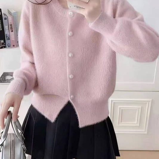 Fluffy pink cardigan features classic pearl style buttons and a soft cozy knit