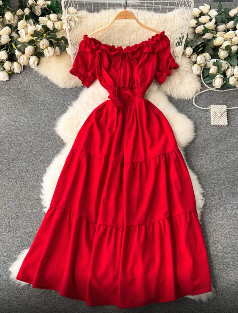 Off-the-shoulder maxi dress with a tiered skirt and ruffled details