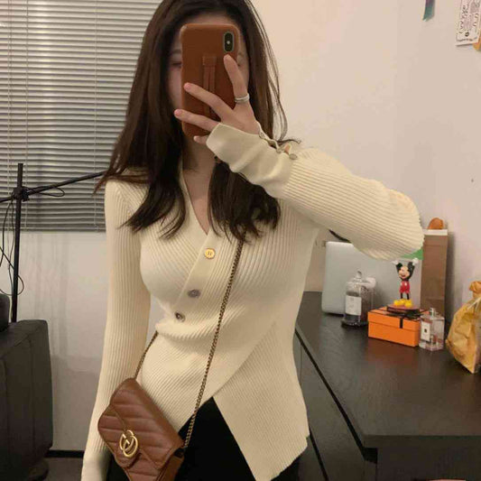 Cream colored asymmetrical ribbed knit cardigan