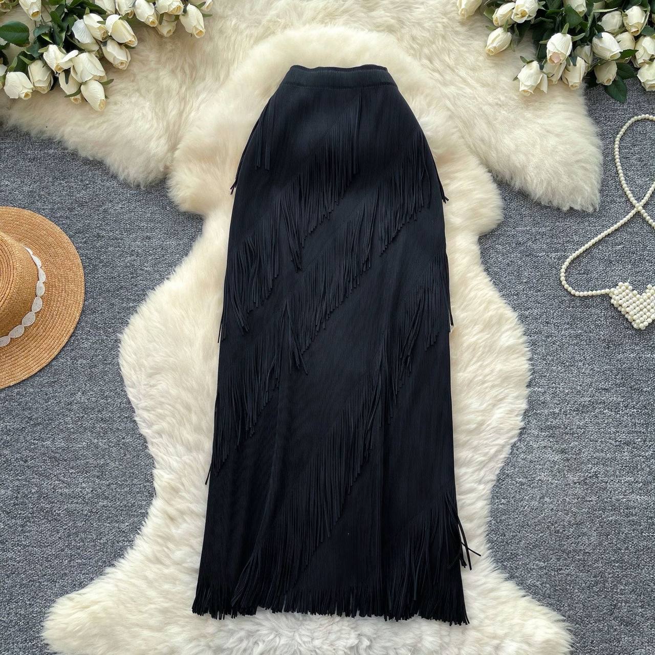 High waisted black maxi skirt featuring diagonal tiered rows of fine tassel fringe