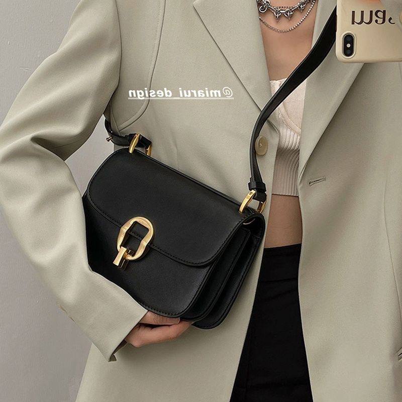Minimalist black flap shoulder bag