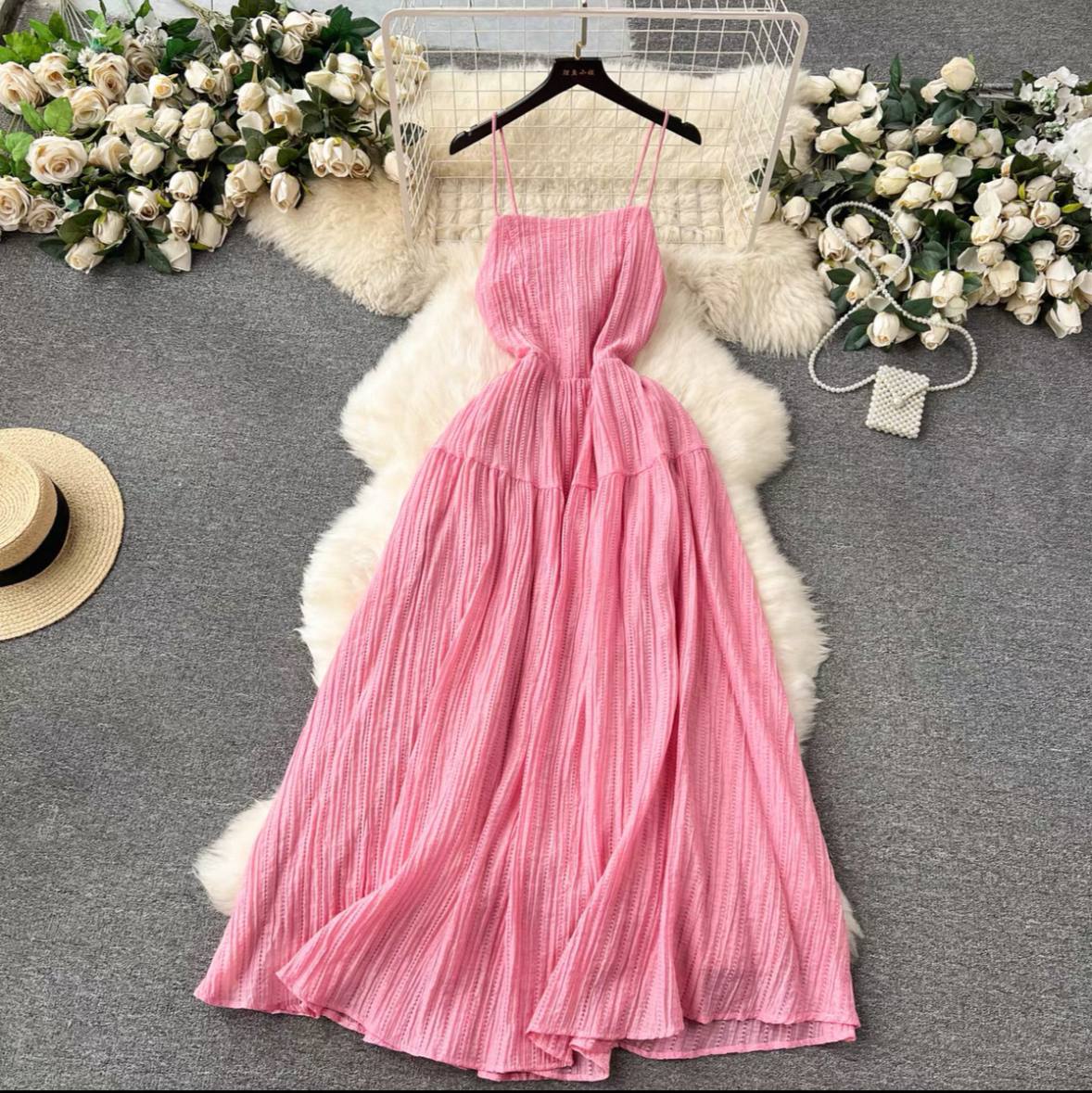 Pink crinkle maxi dress with an open, tie-back detail and a tiered A-line dress