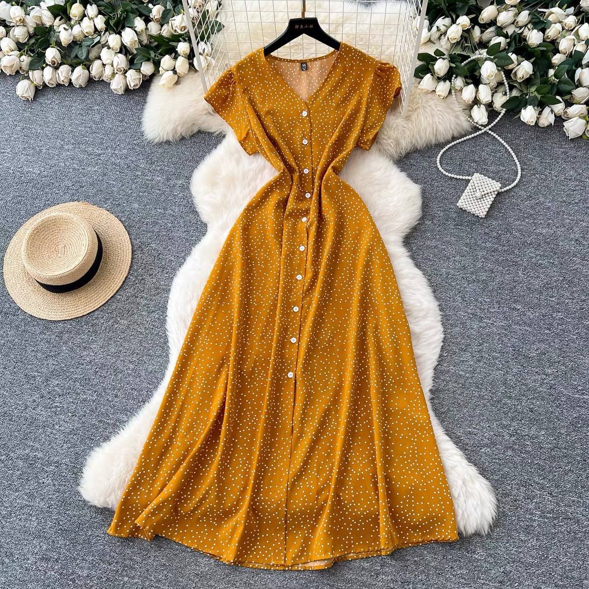 Yellow button-down short-sleeve midi dress featuring a white polka dot pattern