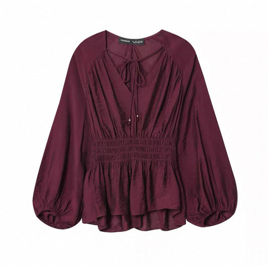 Burgundy smocked blouse with long balloon sleeves and a tie V-neck