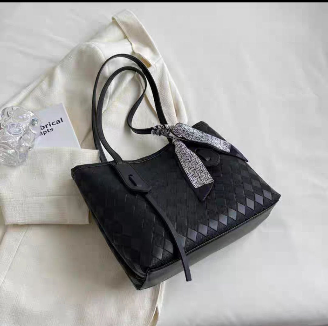 Black woven or geometric-patterned tote bag